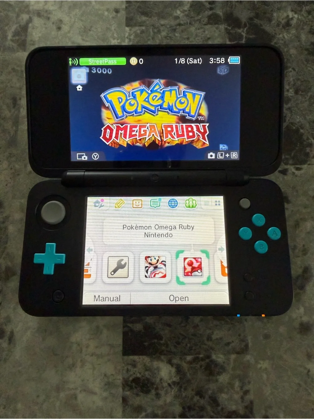 Nintendo Dual-Screen Handheld Console in Black with Teal Buttons